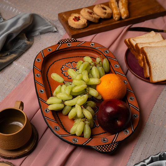 Decorative tray with fruits and toast on a pink surface