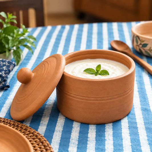 Handmade terracotta curd pot filled with homemade yoghurt and clay lid