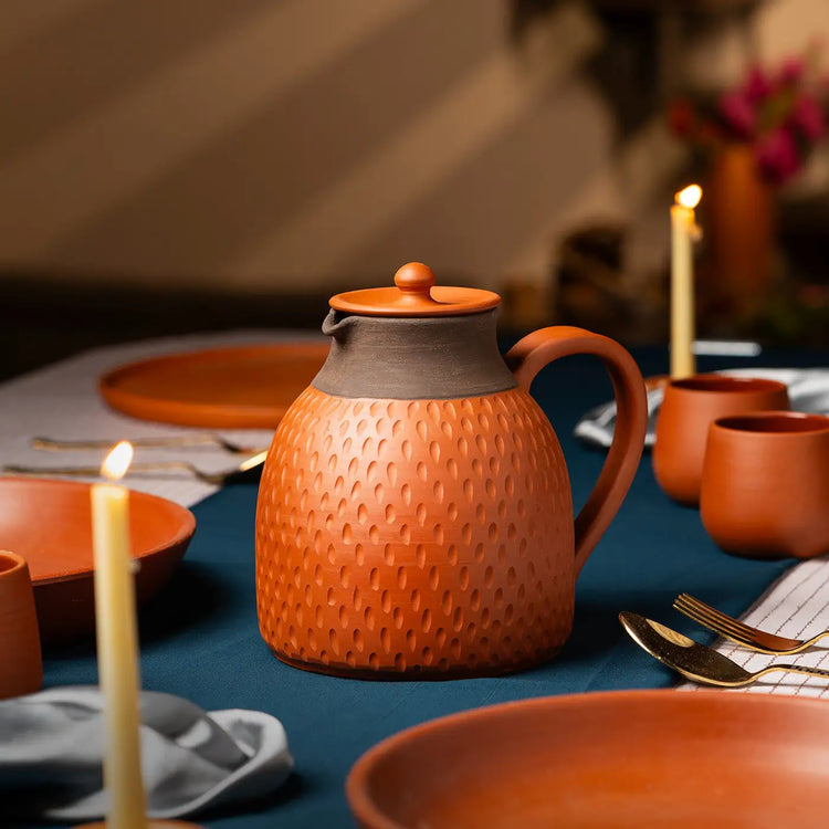 Lifestyle image of handmade terracotta jug on premium dining table
