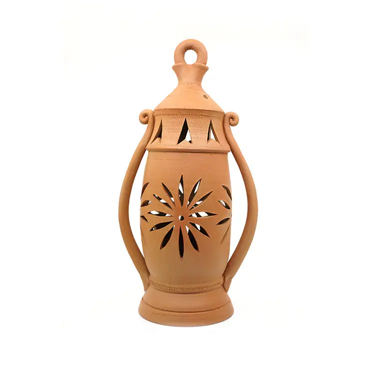 Terracotta lantern with decorative cutout design on a white background