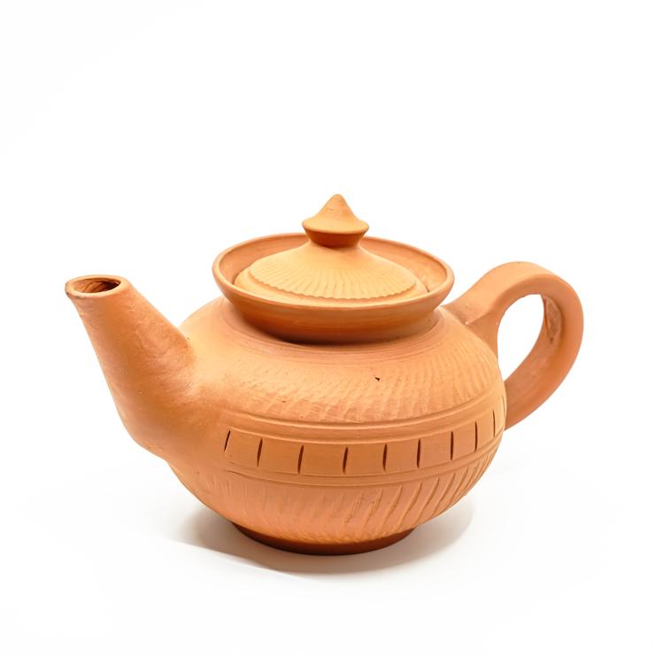 Terracotta teapot with lid on a white background