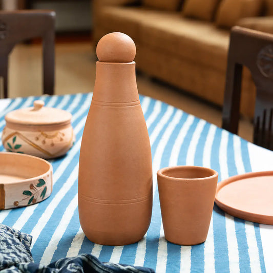 Terra Aseel handmade terracotta water bottle with matching glass 900 ml lifestyle setting