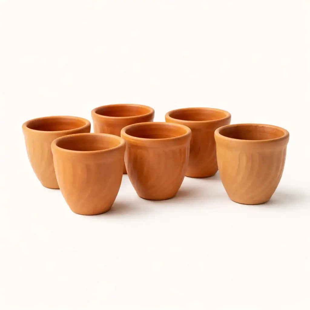 Set of terracotta cups on a white background
