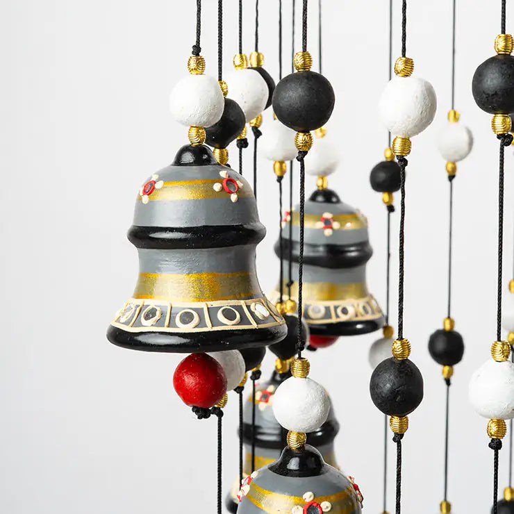 Decorative hanging bells with colorful beads on a white background