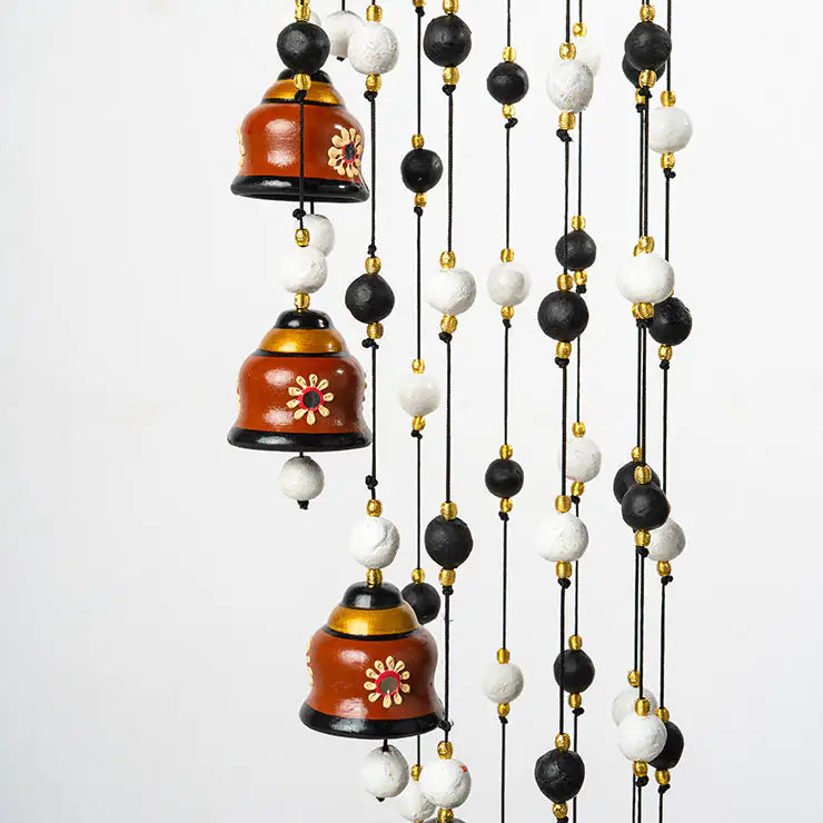 Decorative hanging with bells and beads on a white background