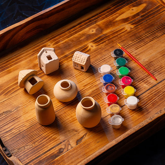 DIY clay mini village painting kit for kids with clay houses, hut, mini pots, paint pots, and brush