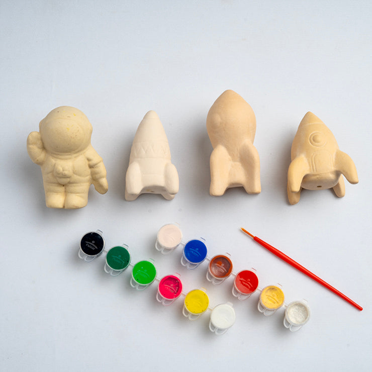 DIY space painting kit for kids with clay rockets, astronaut figure, paint pots, and brush