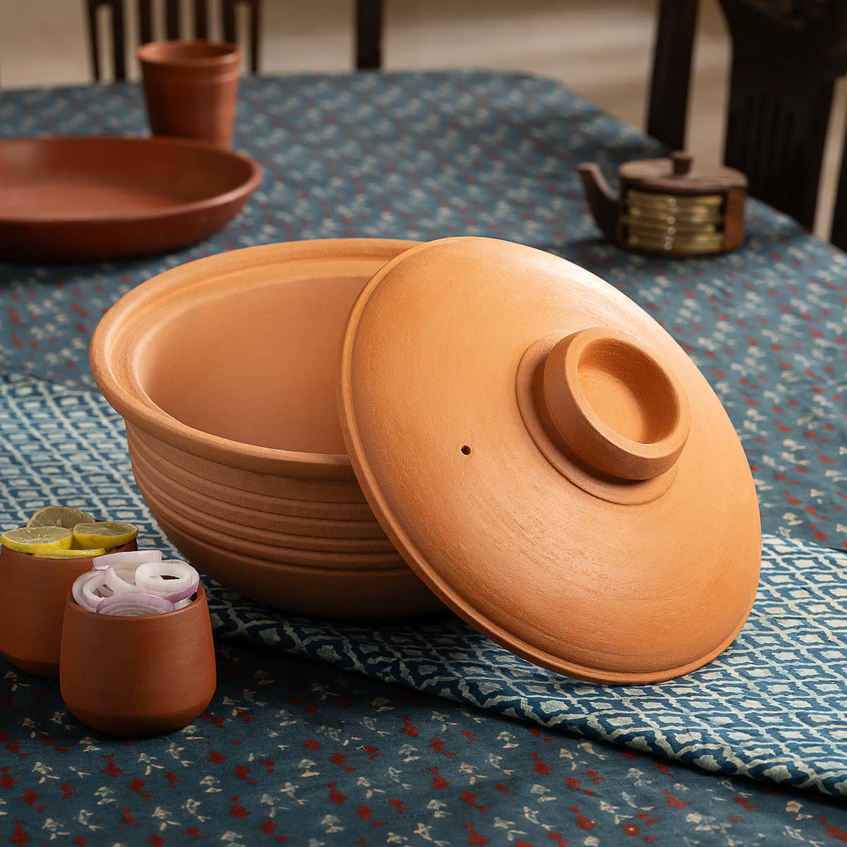 Maison Terracotta large clay cooking and serving pot with lid on dining table