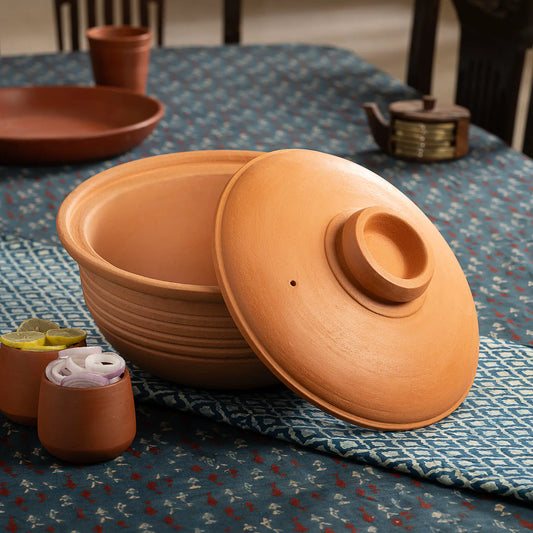 Maison Terracotta large clay cooking and serving pot with lid on dining table