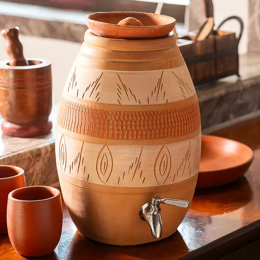 Terracotta dispenser with cups on a wooden surface