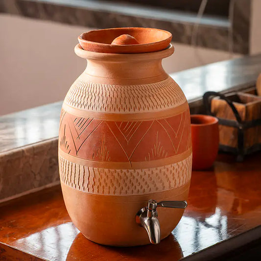 Terracotta water matka with tap from ClayNest collection on wooden table