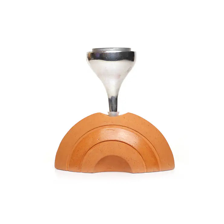 Half moon clay candle holder with carved arc detailing on white background