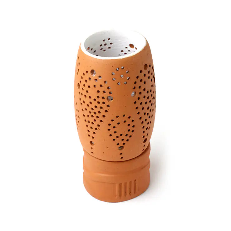 Terracotta candle holder with light-toned interior and lattice holes