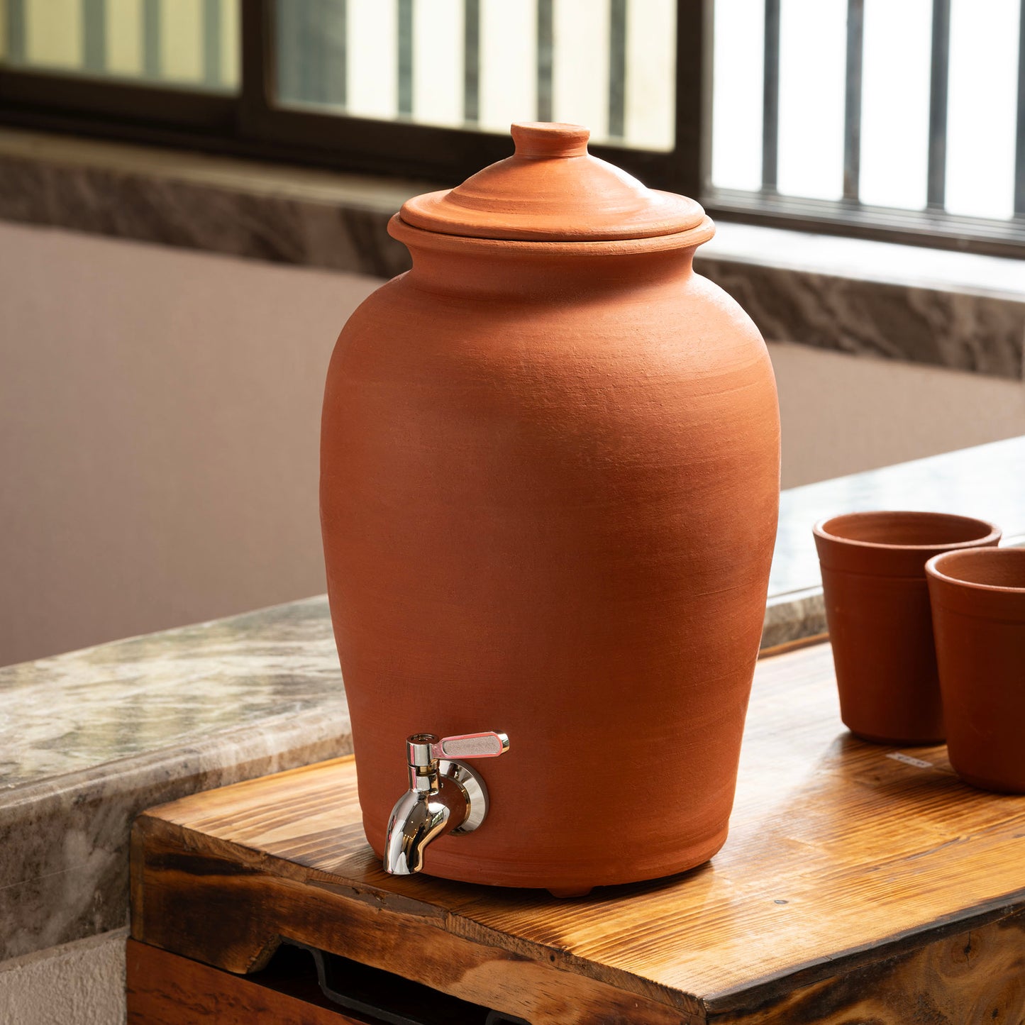5L natural terracotta matka water dispenser with stainless steel tap in home setting