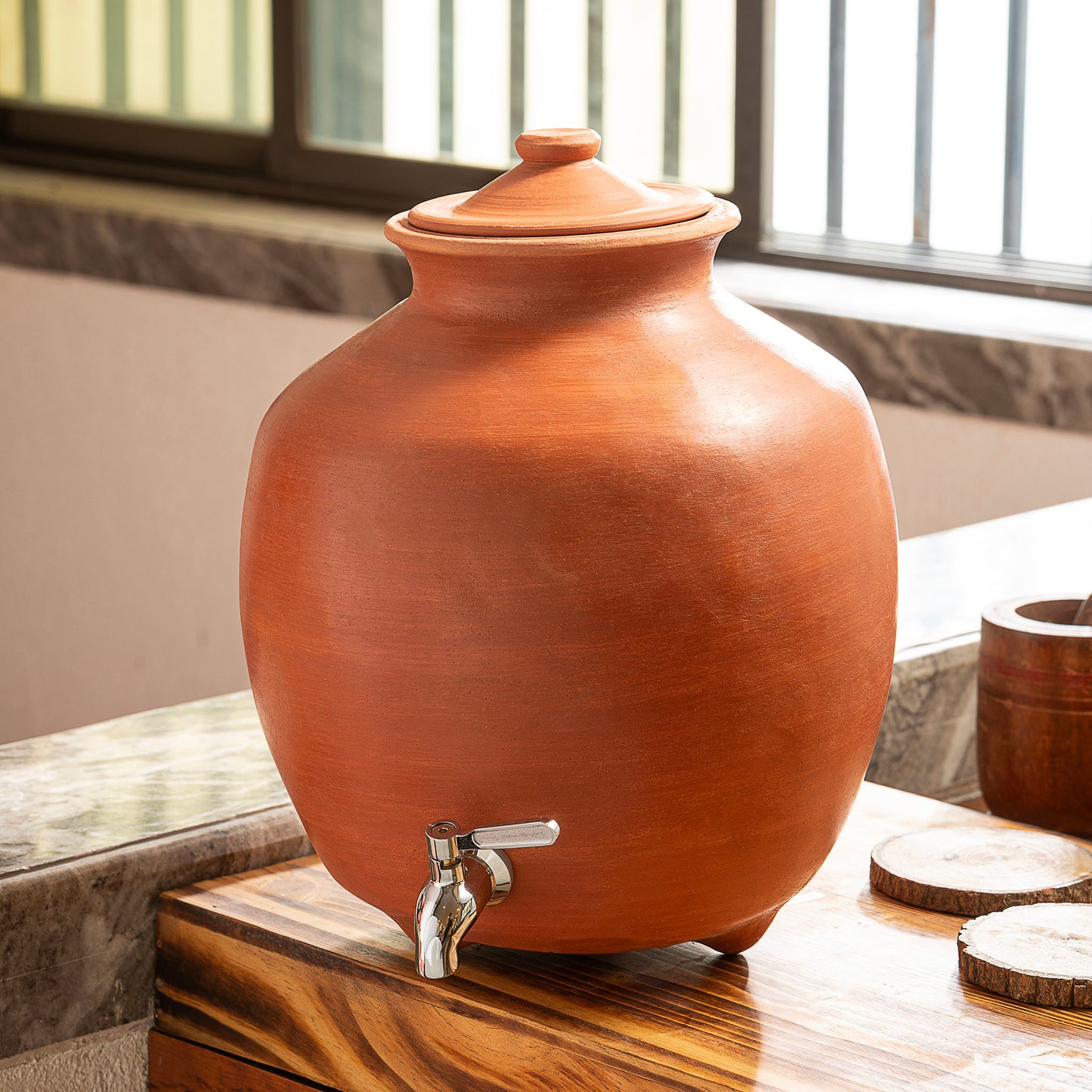 9L natural terracotta matka water dispenser with stainless steel tap in home setting