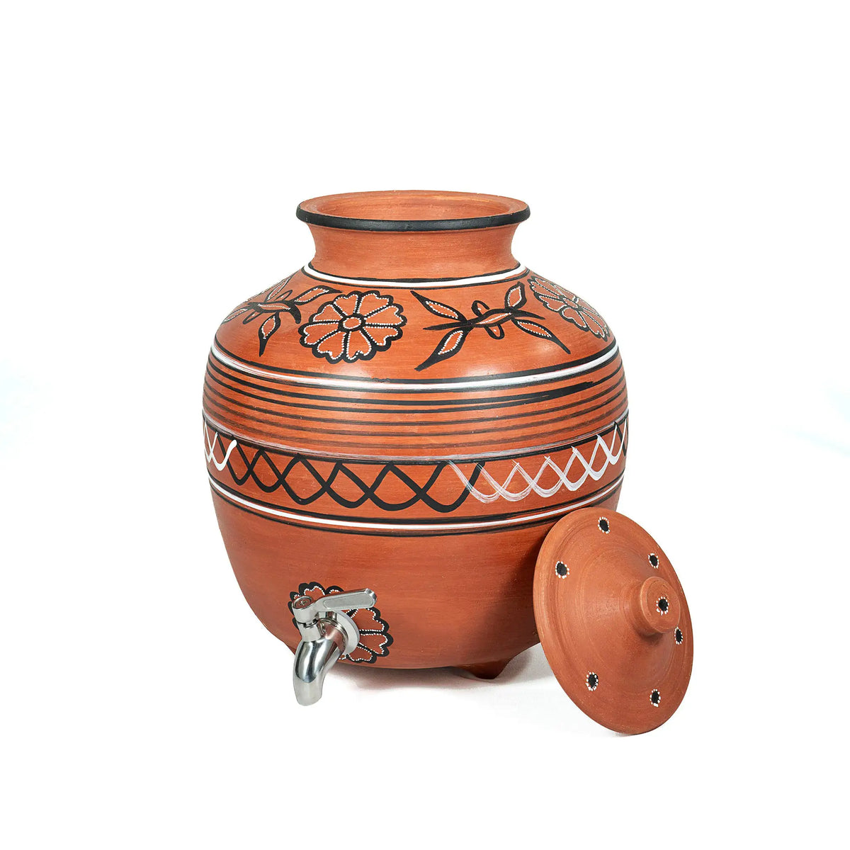 A terracotta clay water dispenser jar with a matching lid, featuring black and white hand-painted floral and geometric patterns, a silver metal spigot, and a white background.