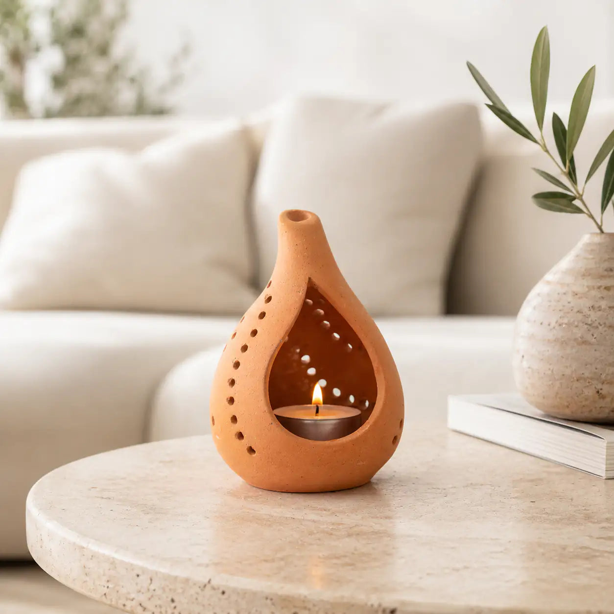 Minimal terracotta tealight holder styled on modern coffee table