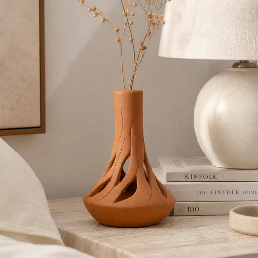 Amour Eclat Root Flow terracotta vase styled beside lamp and books