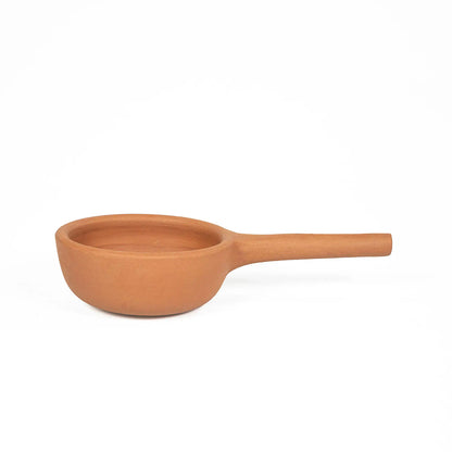 Unglazed handmade clay saucepan with long integrated handle