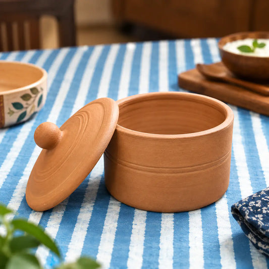 Terra Aseel terracotta curd pot open with clay lid in dining setting