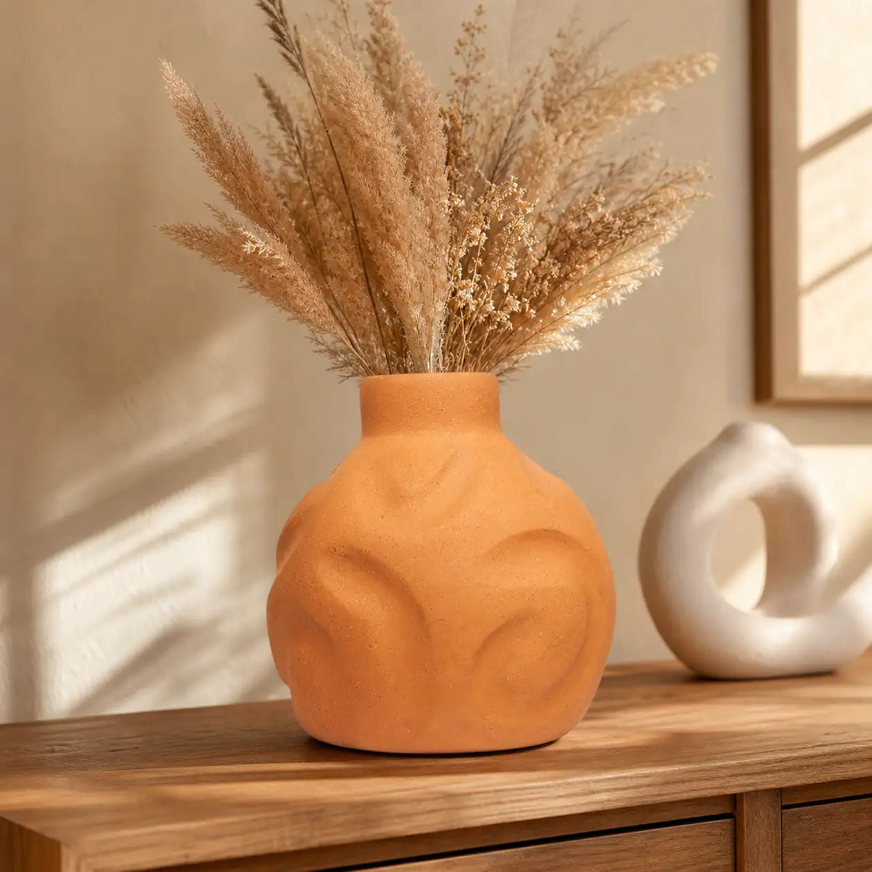 Amour Eclat terracotta vase with dried pampas grass on wooden console