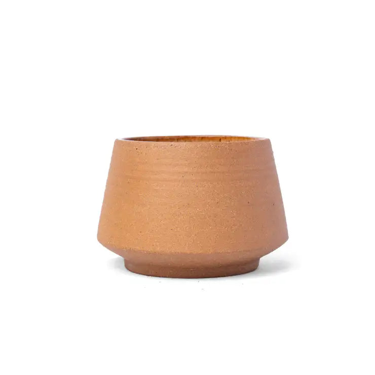 Small clay coffee cup with earthy terracotta finish