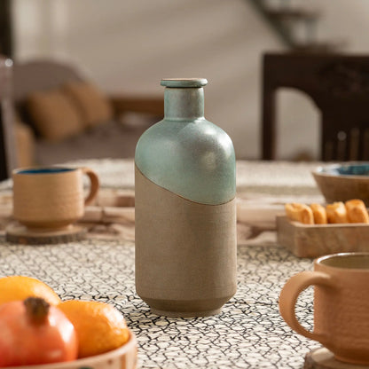 Terra EarthCore 800 ml glazed terracotta water bottle styled on a contemporary dining table