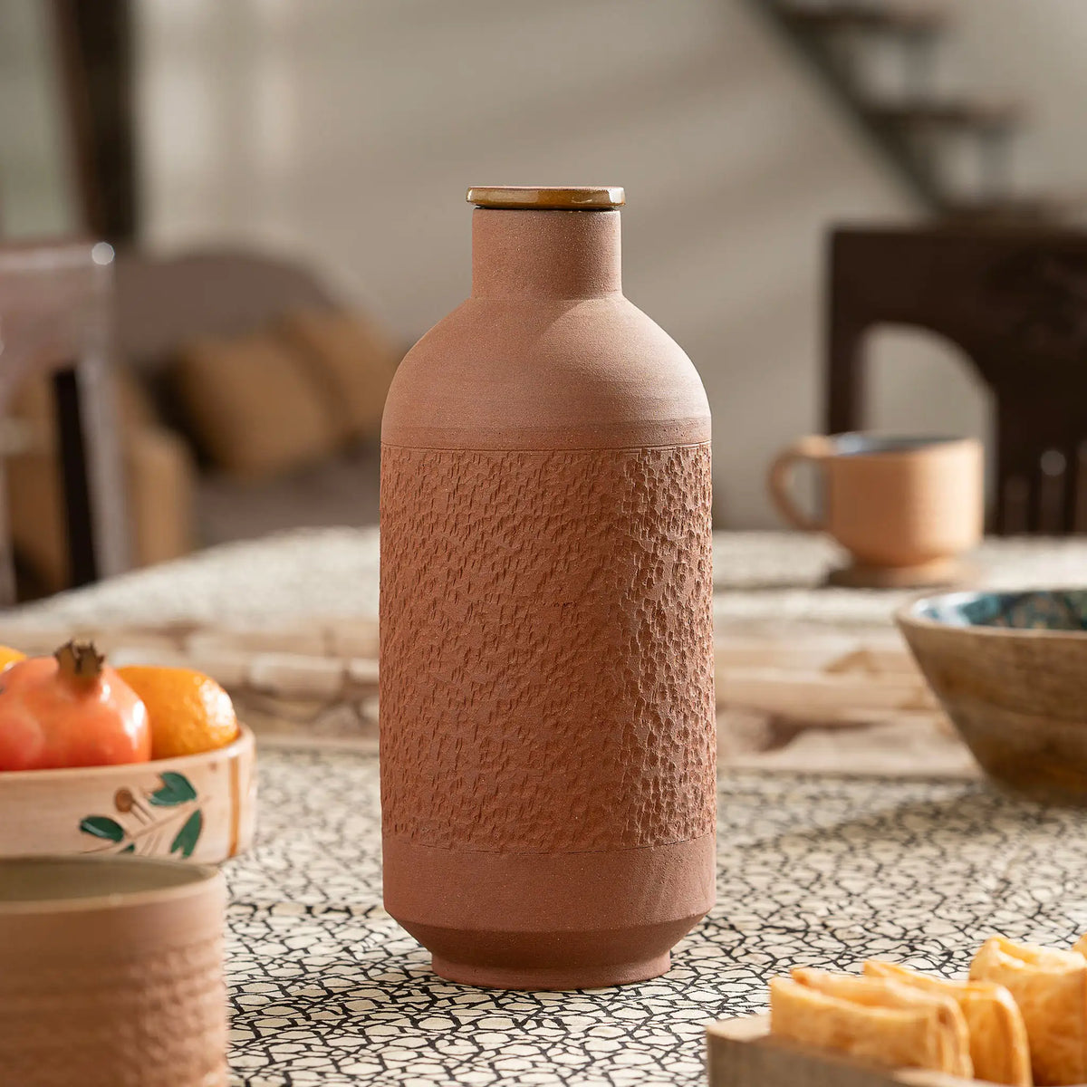 Premium Terra EarthCore 1 liter textured terracotta bottle styled on dining table