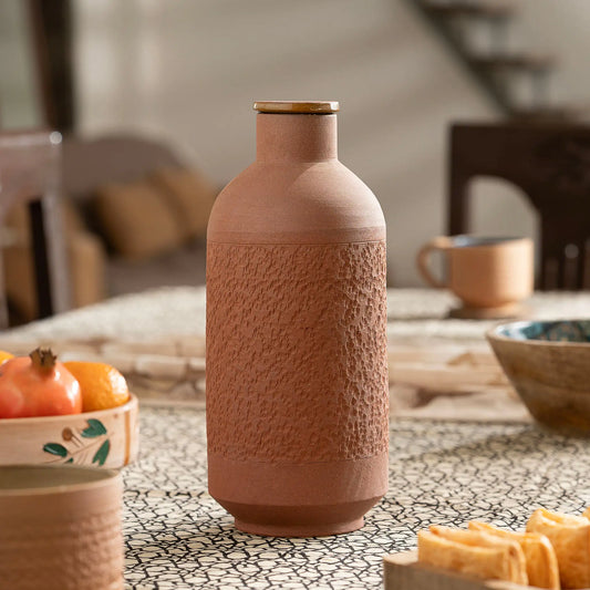 Premium Terra EarthCore 1 liter textured terracotta bottle styled on dining table