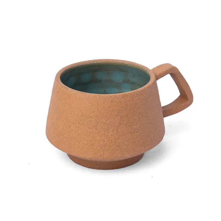 Handmade clay espresso cup with aqua blue interior