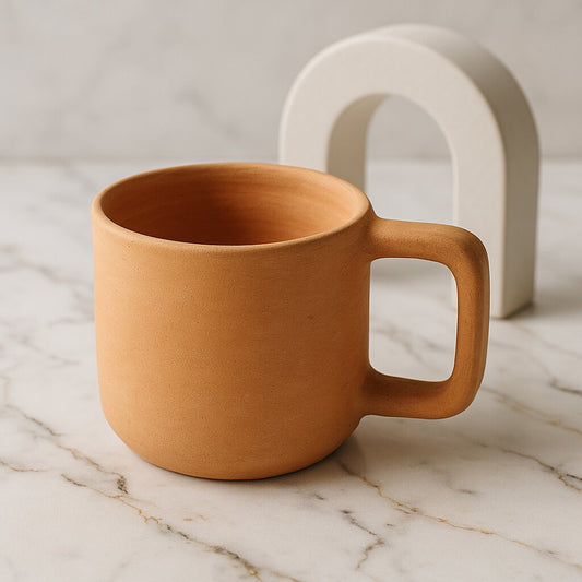 Terracotta mug on a marble surface with a neutral background