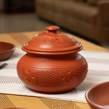 Handmade terracotta serving pot with carved artisan detailing