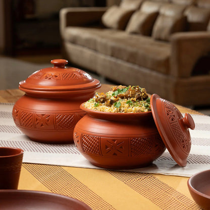 Carved terracotta serving pot styled with biryani for table serving