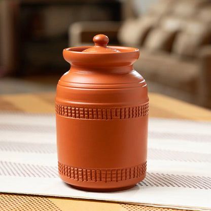 Large terracotta countertop storage jar in lifestyle setting