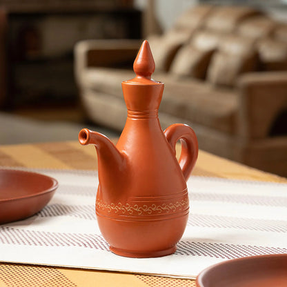 Handmade clay water jug with decorative detailing and terracotta lid