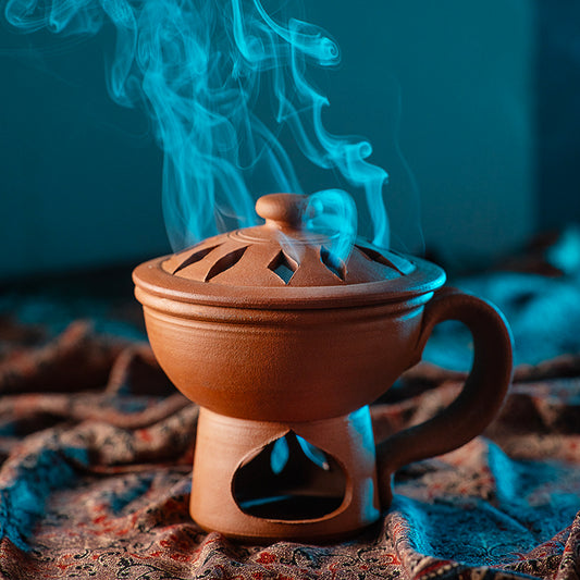 ClayRootz handmade terracotta incense / bakhoor burner with lidded vented top, handle and pedestal base, smoke rising
