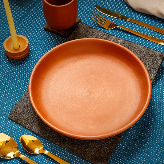 Terracotta dining plate styled on table setting