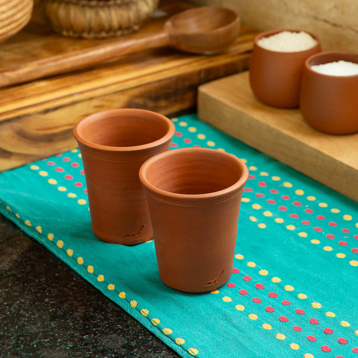 Pair of ClayRootz handmade terracotta glasses 200 ml in lifestyle setting
