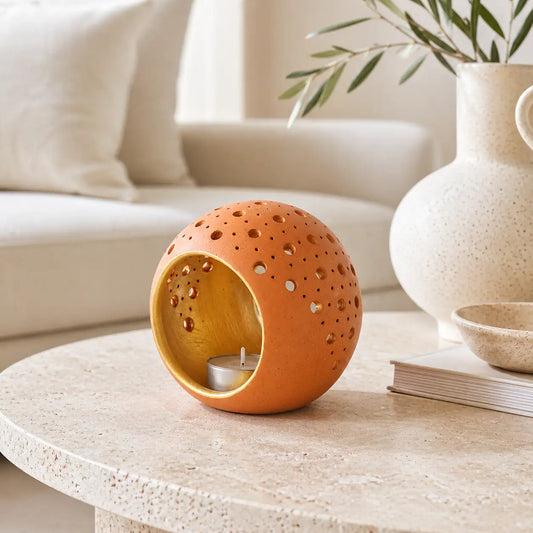 Terracotta cutwork candle holder styled on a modern coffee table