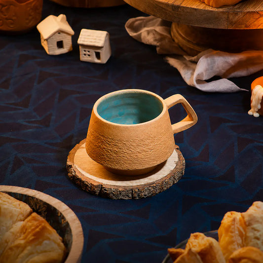 Handmade clay espresso cup with aqua blue interior