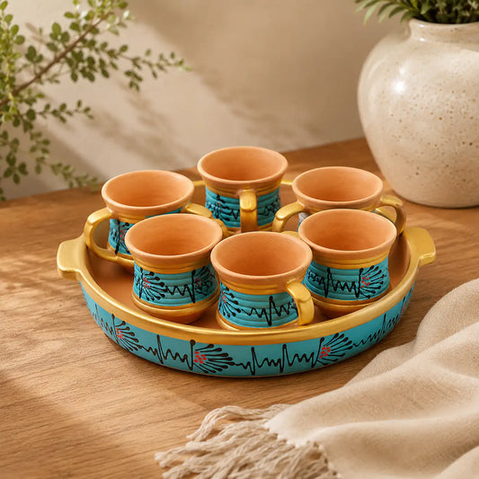 Set of Clay cups with a decorative tray on a wooden surface