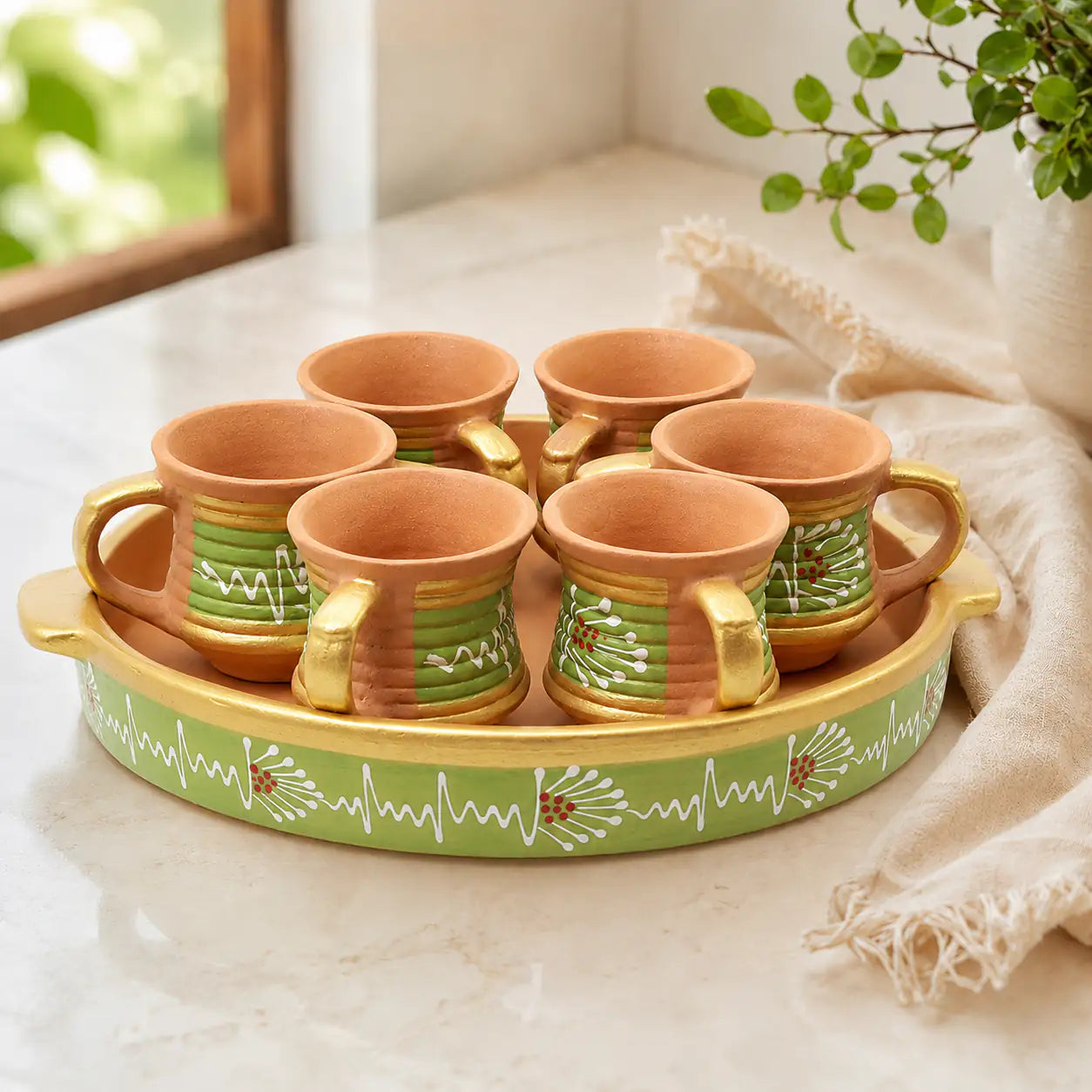 Set of Clay mugs with a decorative tray on a light surface.