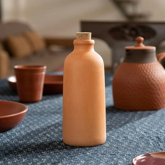 Terrapura Curve handmade clay water bottle 500 ml in lifestyle dining setting