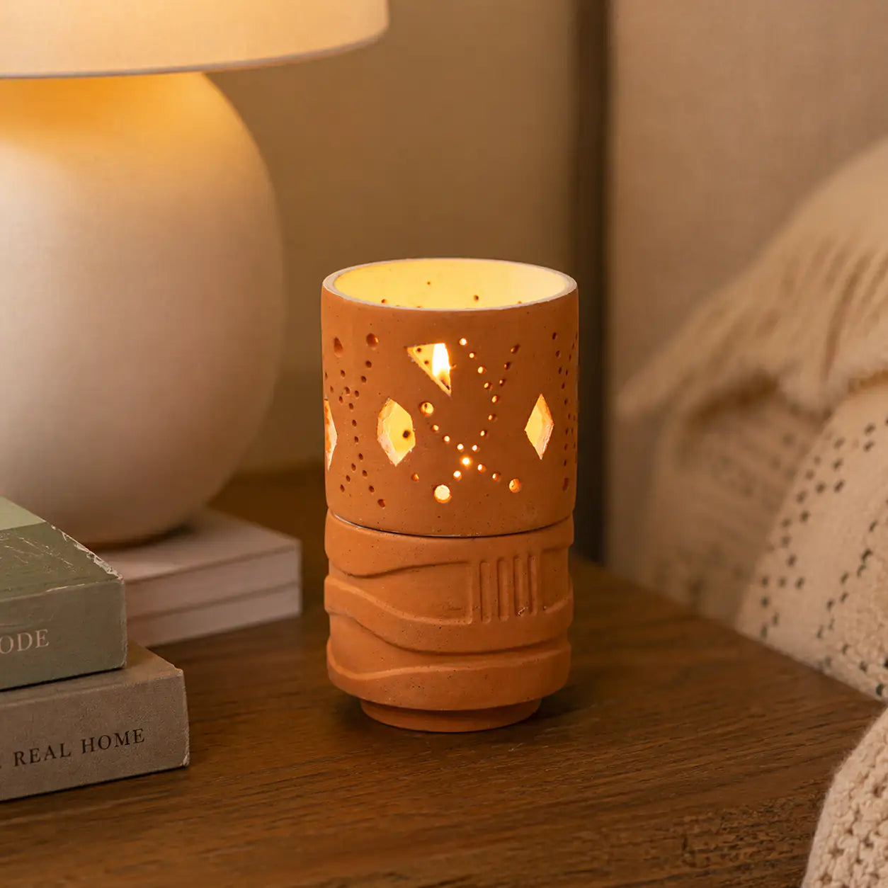 Amour Eclat terracotta candle holder styled on woven tray with home décor