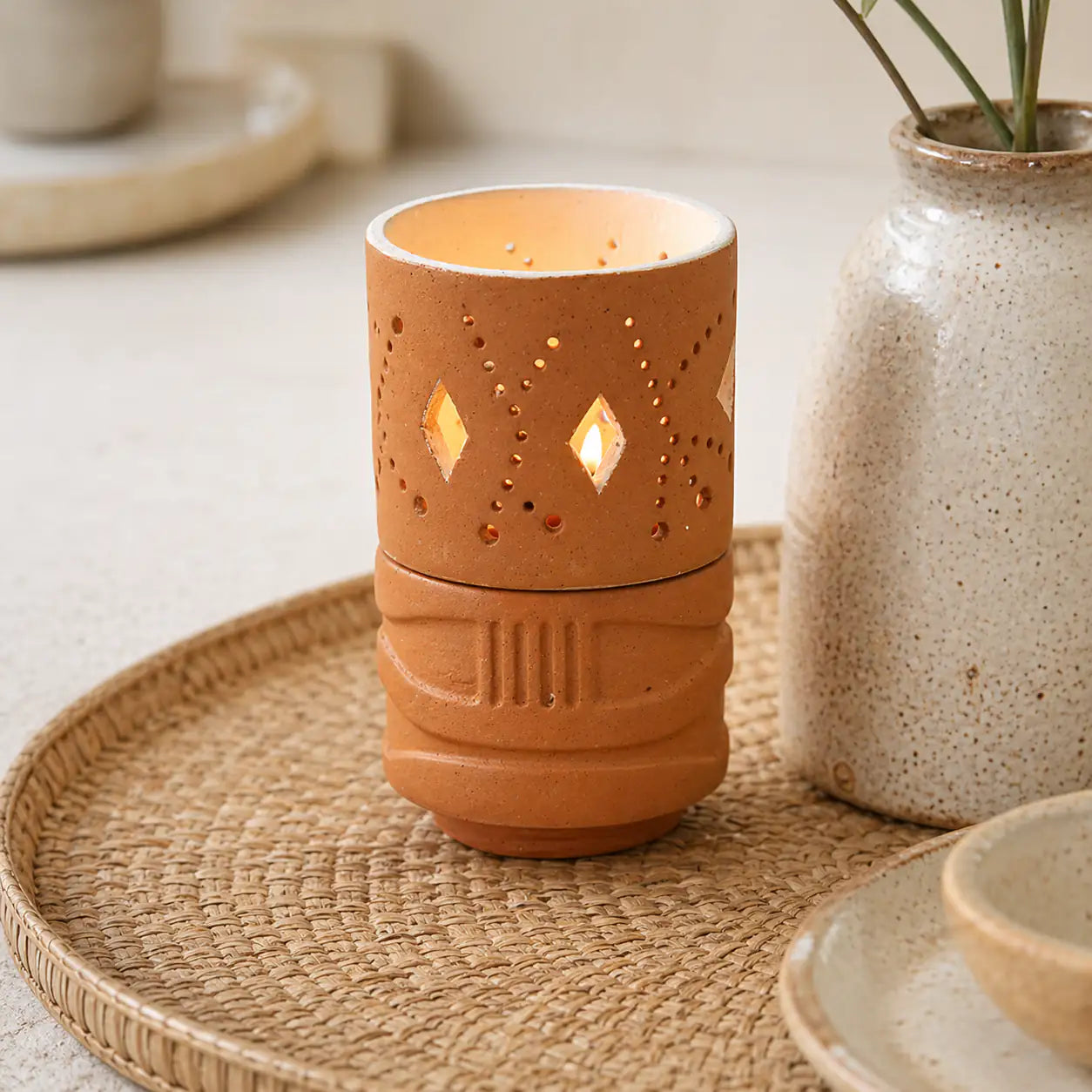 Amour Eclat terracotta candle holder styled on woven tray with home décor