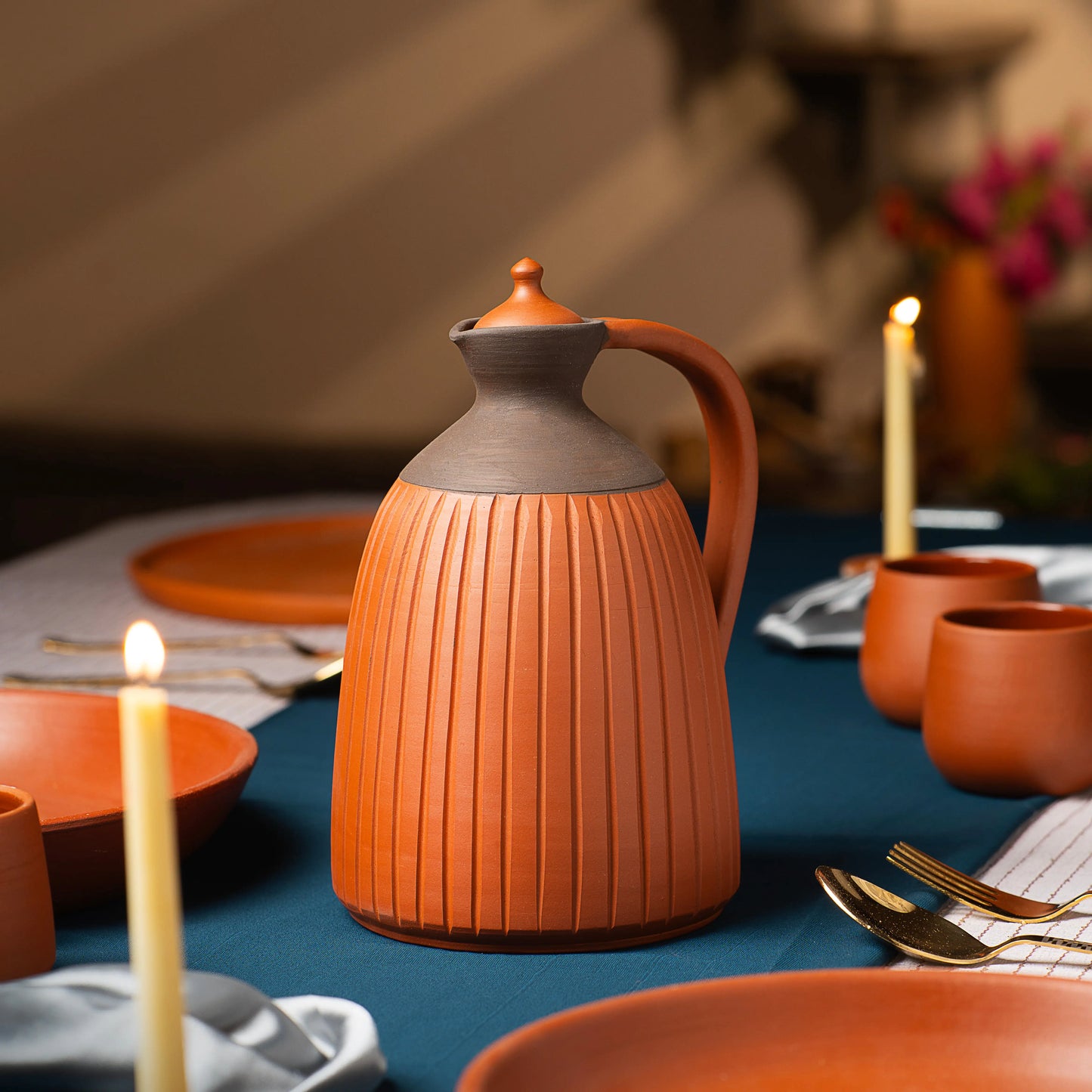 Lifestyle image of ribbed terracotta jug on elegant dining table